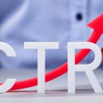 Mão segura seta vermelha subindo ao lado das letras CTR, ilustrando como calcular o CTR.